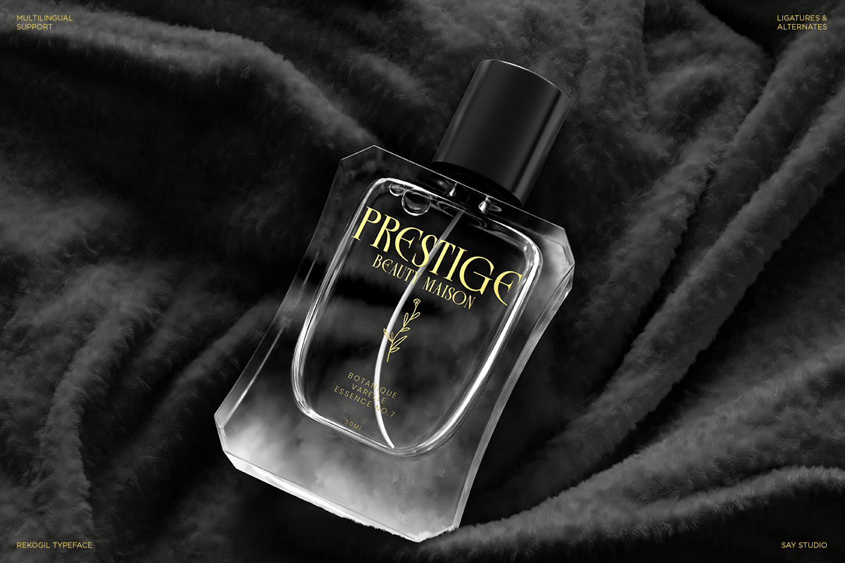 Luxury perfume bottle mockup with gold lettering on black fabric backdrop