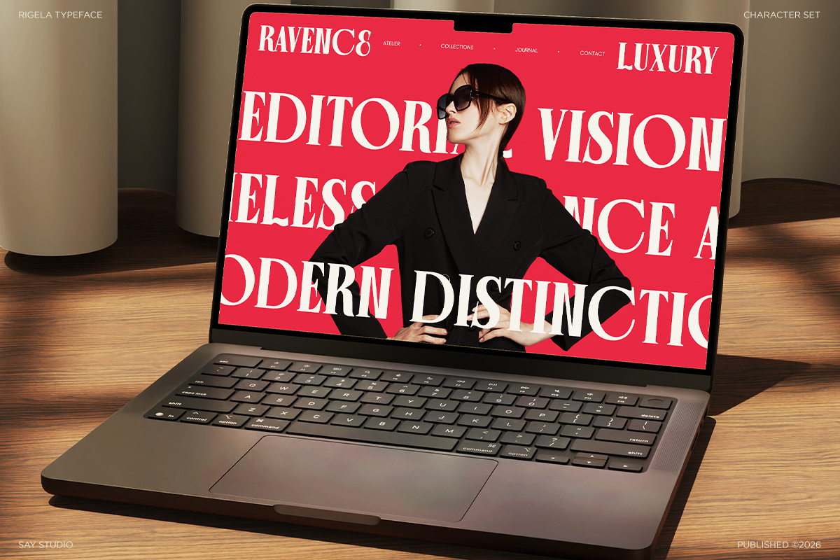 Laptop mockup showing bold red website design with white serif typography, model in black blazer against vibrant background