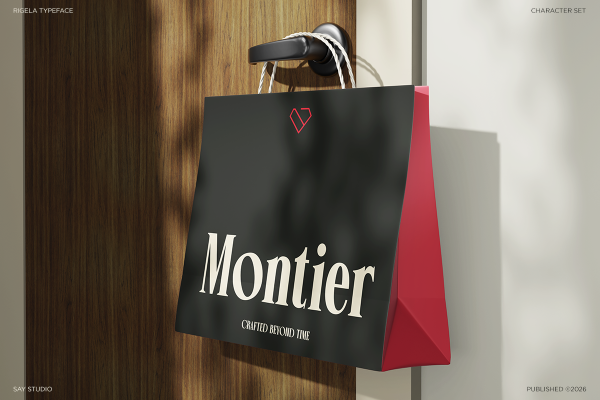 Black shopping bag with "Montier" text, red heart logo, pink side panel, rope handles