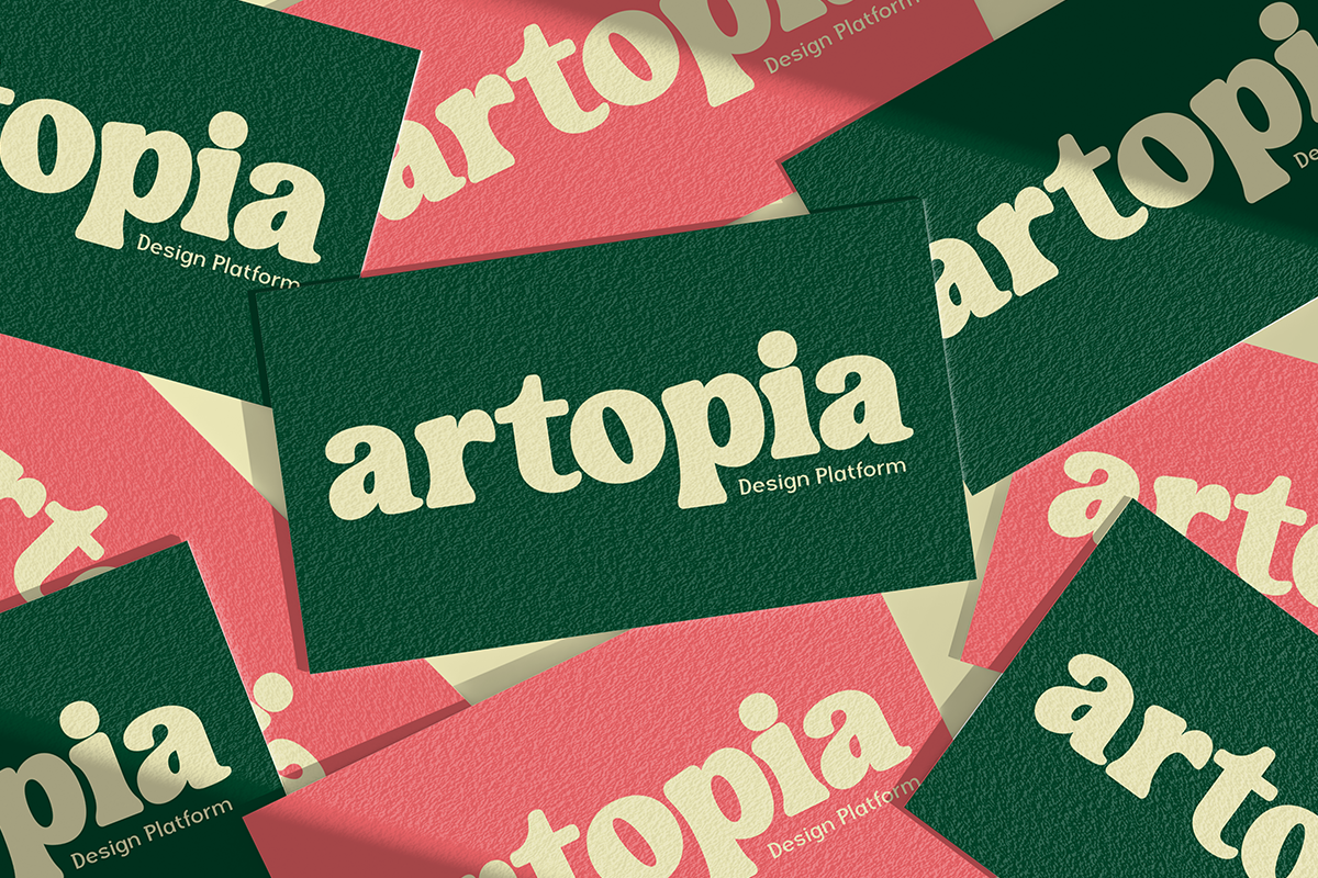Overlapping business cards in forest green, coral pink with cream serif lettering showing design platform branding