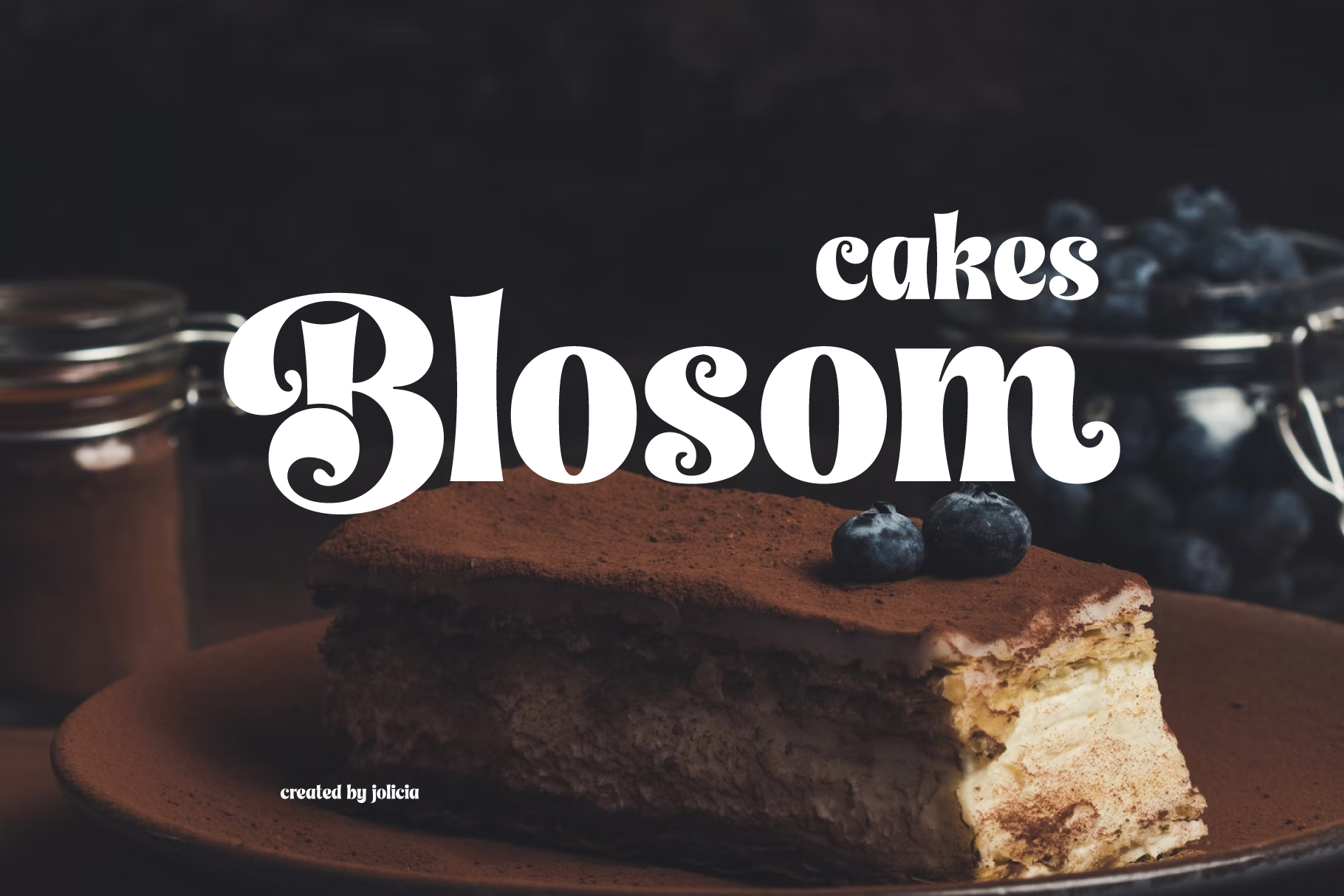 Blossom Cakes serif font layered over moody chocolate cake shot with blueberries