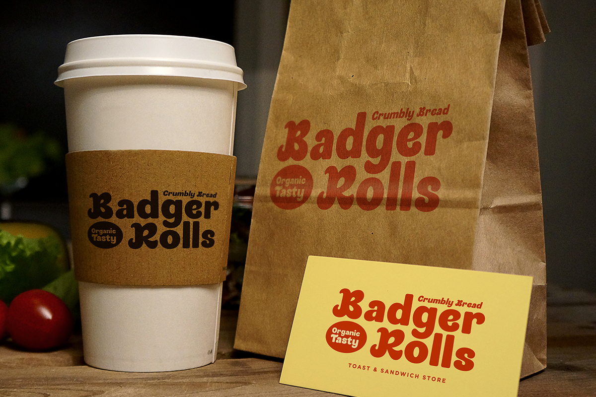 Badger Rolls bakery branding mockup with coffee cup, paper bag, business card in red retro typography