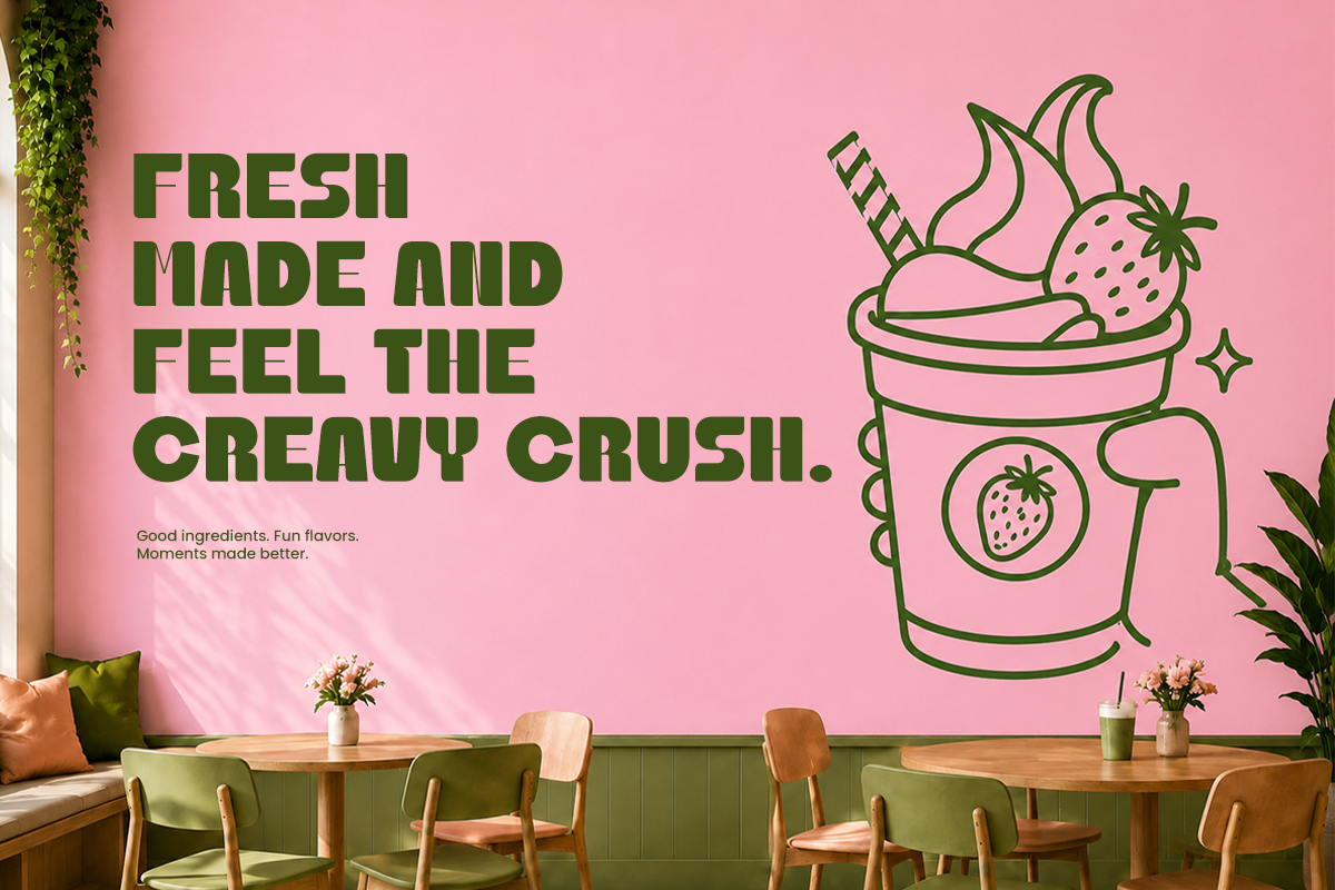 Bright pink wall mural with bold green text about creamy smoothies, illustrated cup with strawberries