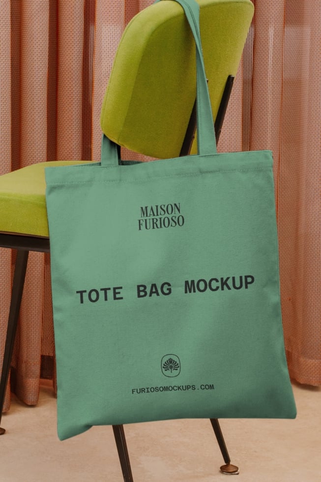 Mint tote bag mockup on chartreuse chair with terracotta curtains behind