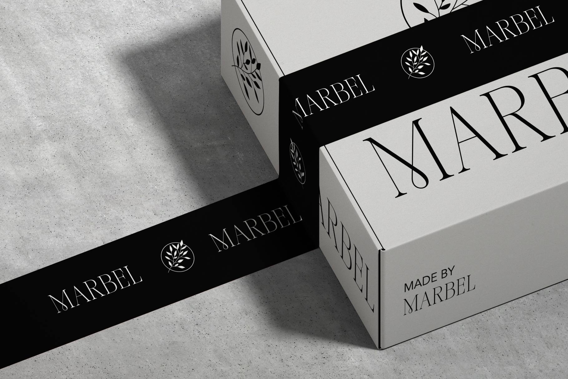 Luxury skincare box mockup with black band, serif typography, botanical logo on concrete surface