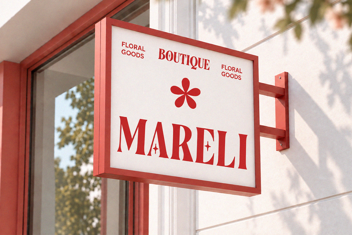 Red storefront sign for Marelli floral boutique with flower icon on storefront window