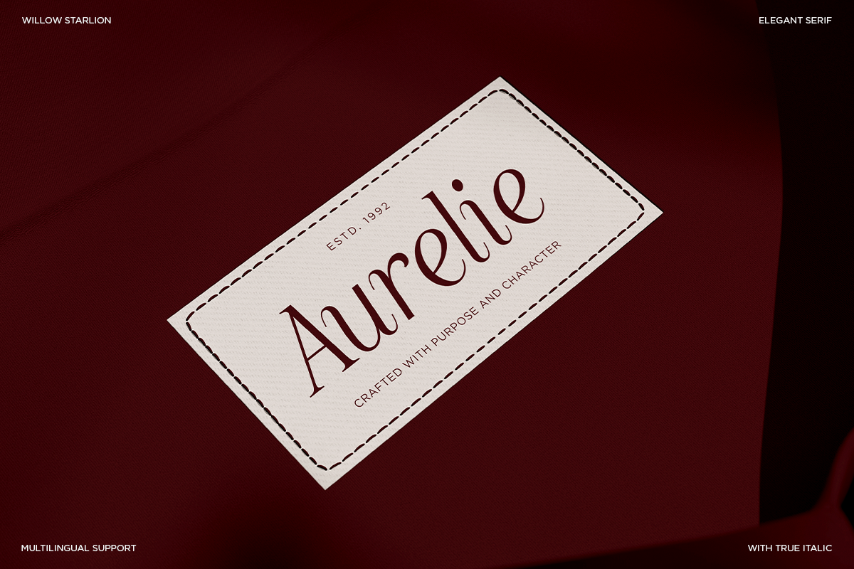 Cream label mockup with Aurelie serif font in deep burgundy on dark red background